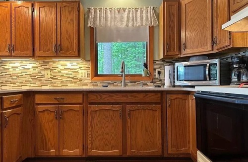Elmira Cottage | Cozy beachfront cottage in the woods with walkout basement and wrap-around porch