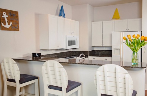 Bay Harbor Condo | Experience luxury at Captain Suite 219 in Bay Harbor, MI, featuring a cozy bedroom and village view.