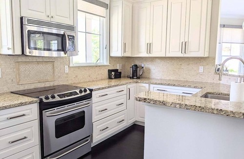 Bay Harbor House | Experience luxury in this 4-bedroom home with stunning lake views in Bay Harbor.
