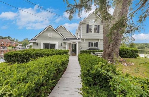 Wolverine Lake House | Oak Island: Waterfront Bliss with Hot Tub and Sandy Beach