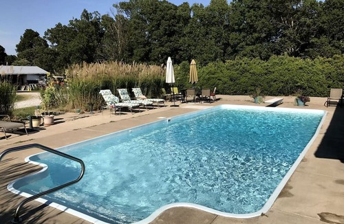 Crofton Cabin | Pet-Friendly Log Cabin with an Outdoor Pool near Crofton, Kentucky