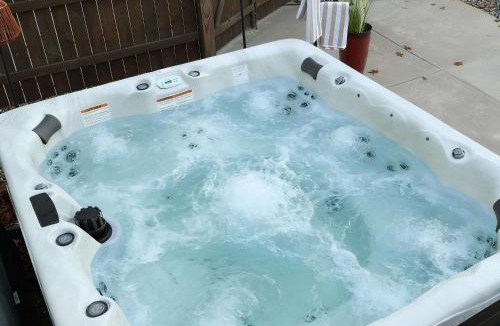 Muskegon House | Pine & Paddle Getaway Game Room Hot Tub Pool