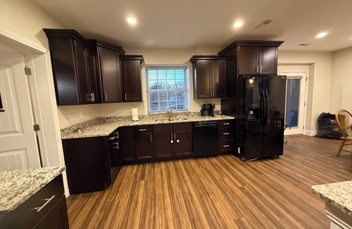 Caseyville Apartment | Private one-bedroom suite with king bed, walk-in closet, and ensuite bath featuring double vanity and safety grab bars. Enjoy serene pond views from your patio, full kitchen, and dedicated workspace for a comfortable stay.