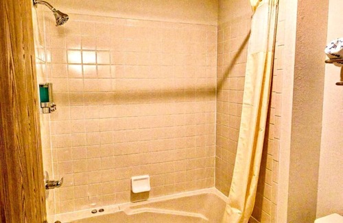 Boulder Junction Apartment | Two queen beds, private bathroom, jetted tub, mini fridge, and single-serve coffee maker.