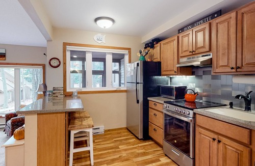 Maple City Condo | Updated, charming condo near Lake Michigan with porch, washer/dryer, fireplace