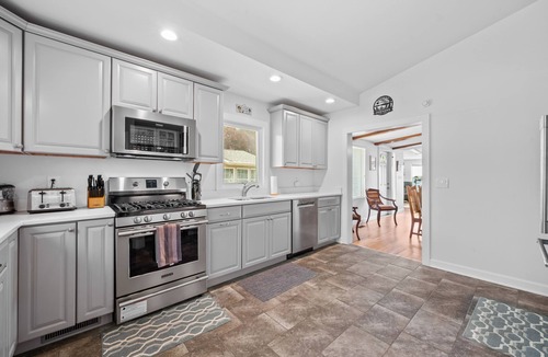 Paw Paw Lake House | Wake up to sunrise views over Paw Paw Lake at this cozy lakefront cottage with a dock, hot tub, and room for 8.