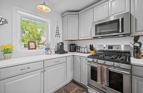 Paw Paw Lake House | Wake up to sunrise views over Paw Paw Lake at this cozy lakefront cottage with a dock, hot tub, and room for 8.