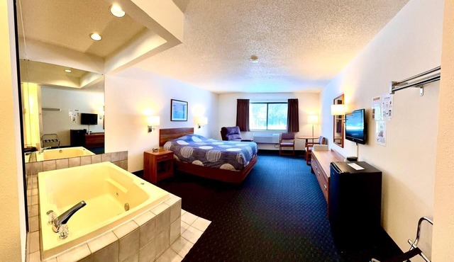 One queen bed, private bathroom, two-person whirlpool tub, mini fridge, and single-serve coffee maker. in Boulder Junction