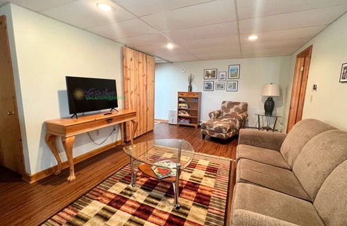 Maple City Cabin | Lodge-style multi-level home at the Homestead in Glen Arbor. Deck with grill.